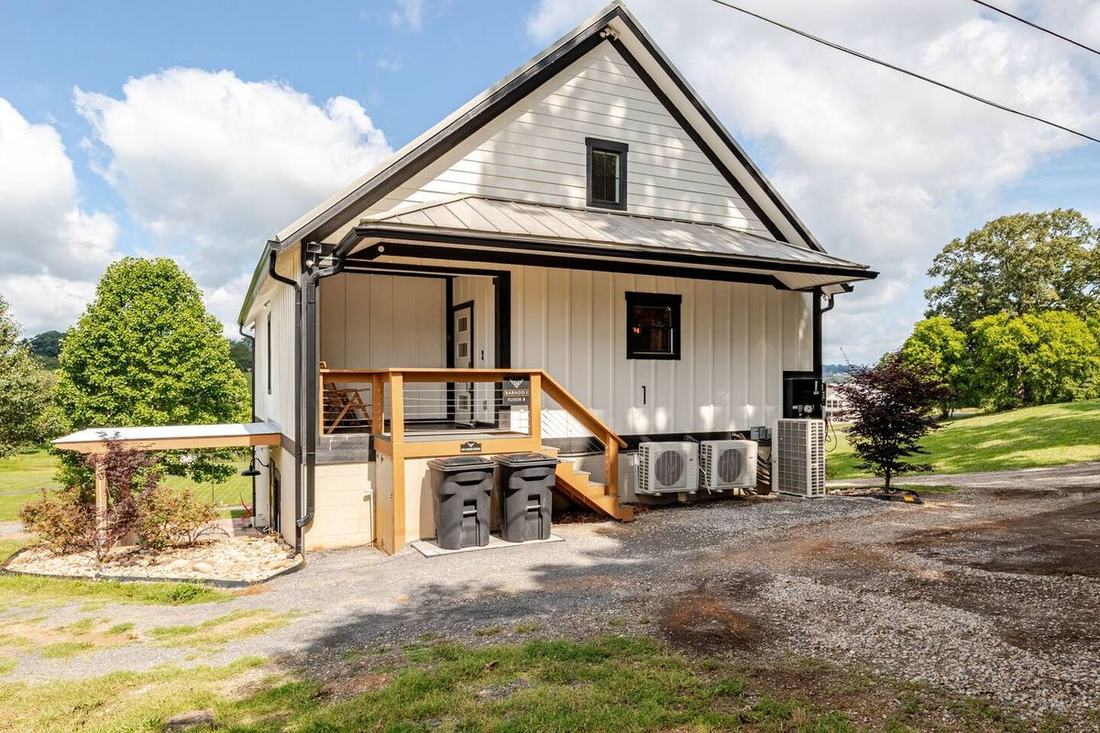 Take all three barndominiums at once — Fairland Ridge books Barndo 1, 2 and 3 together at the fluffy cow farm near the Smoky Mountains, board-and-batten buildings around the pasture.
