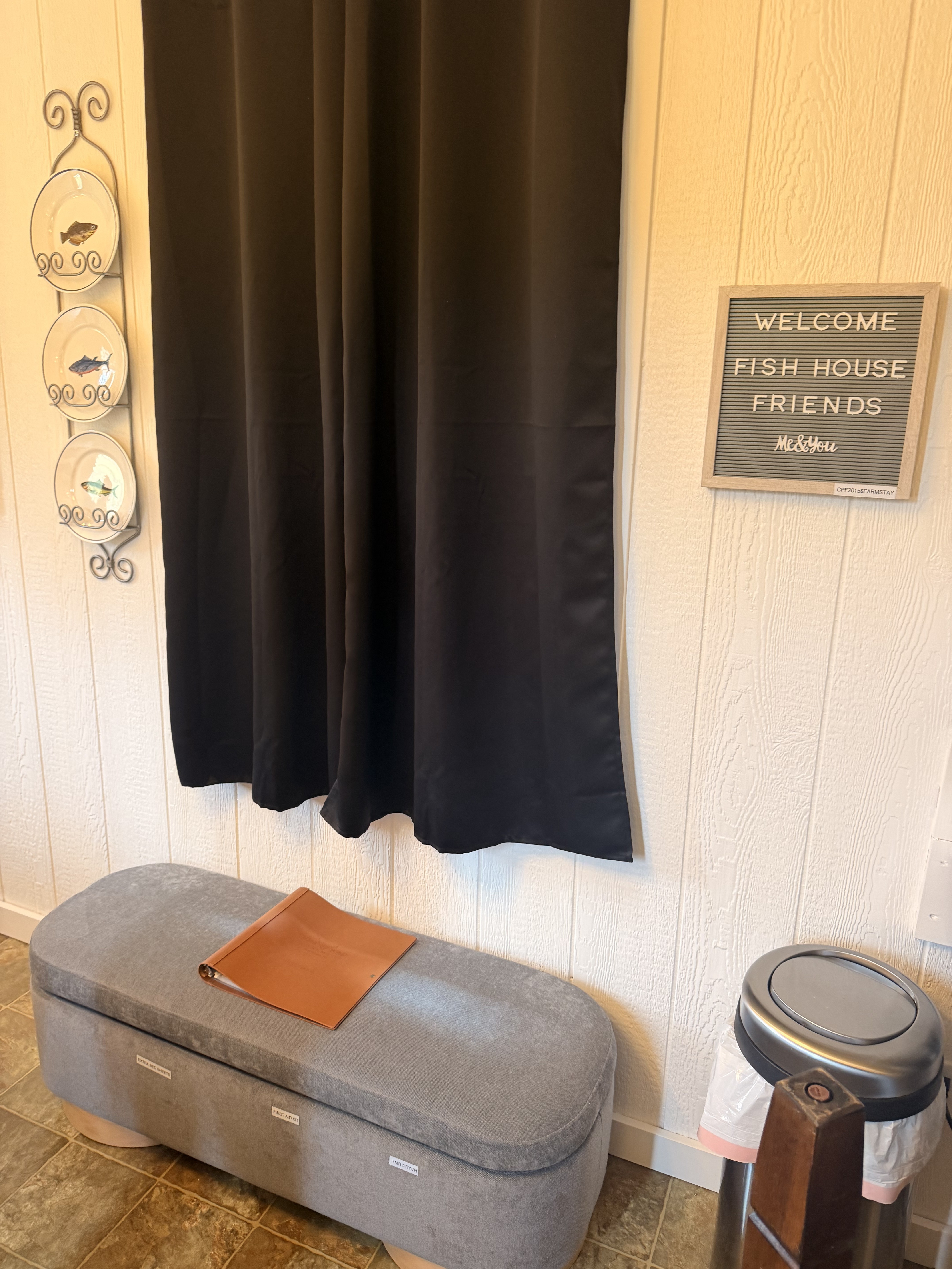 Coastal entry nook with storage bench and blackout curtains